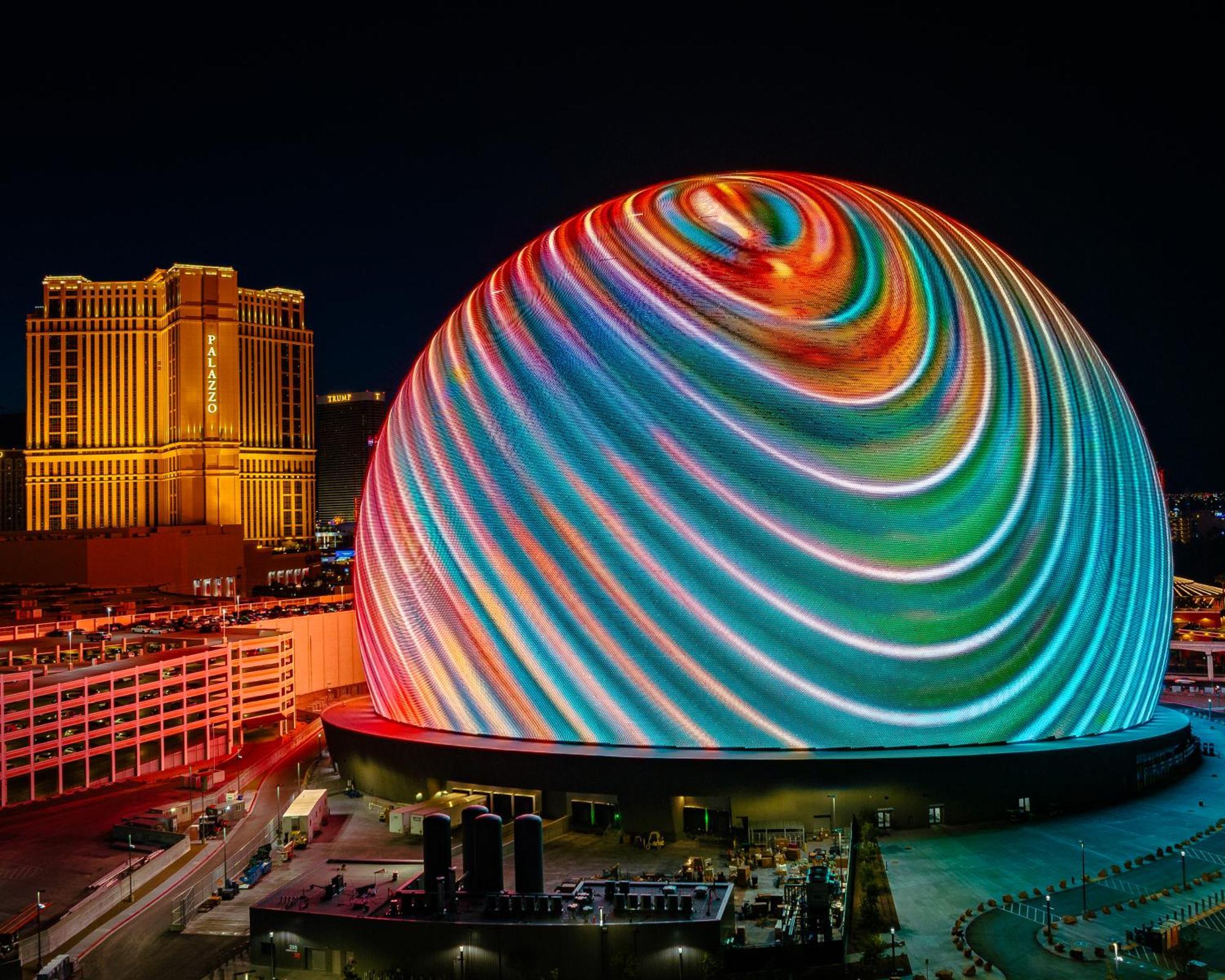 Hotel The Palazzo at The Venetian® Las Vegas Esterno foto The photo shows a large, dome-shaped structure illuminated with colorful, swirling lights and patterns, creating a vibrant display. The dome is prominently featured against a night sky, highlighting its unique design. In the background, there are tal